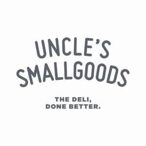 Text logo reading "UNCLE'S SMALLGOODS" in large, curved letters, with "THE DELI, DONE BETTER." in smaller, bold letters below on a transparent background. Opdee Digital Marketing