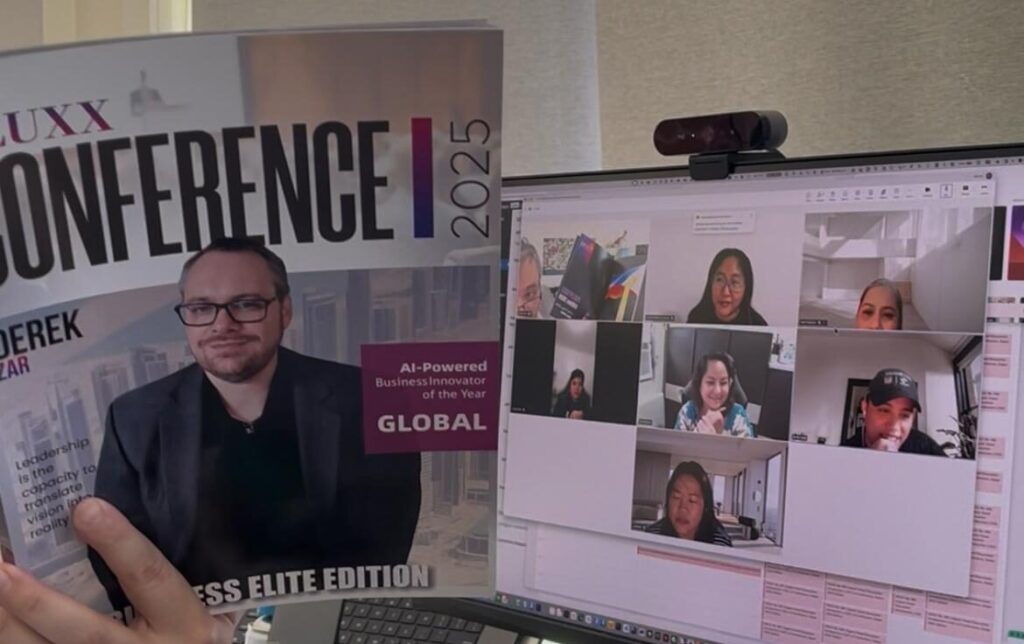 A person holds a magazine featuring a man on the cover that reads “CONFERENCE 2025,” in front of a computer screen displaying a virtual meeting with multiple people on a video call. Opdee Digital Marketing